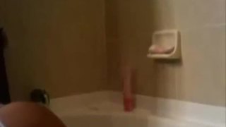 Busty babe gets wet in the bath tub